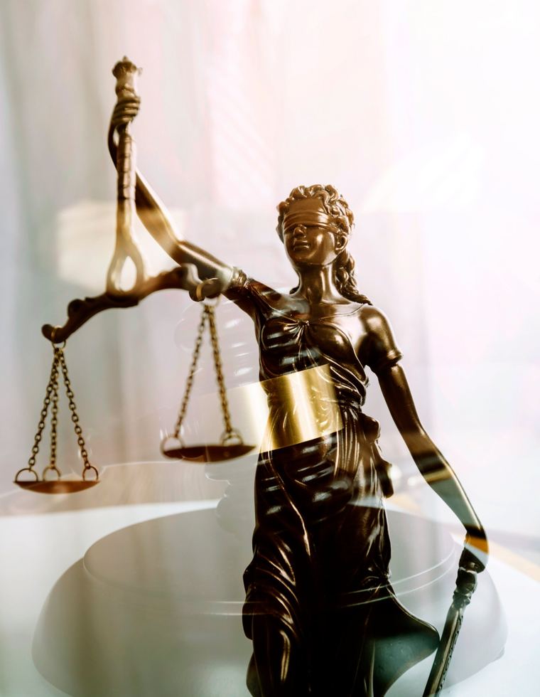 Bronze Lady Justice statue holding the scales