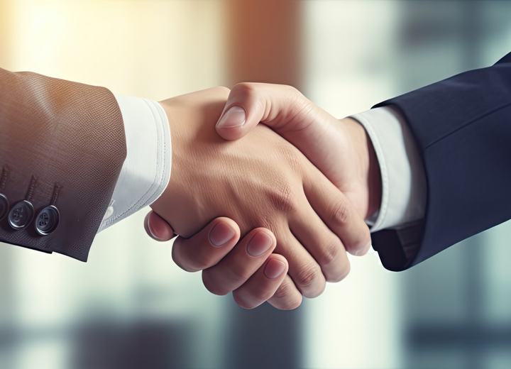 Two professionals shaking hands on a deal