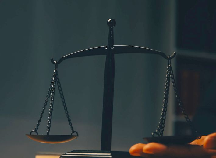 Scales of justice and a gavel on a desk